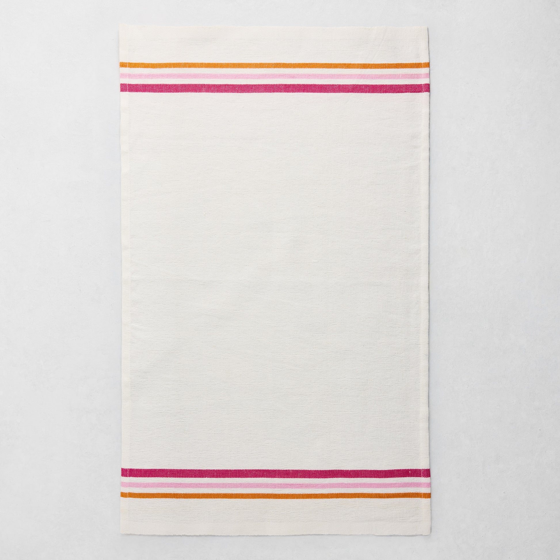 White cotton-linen hand towel with pink, orange, and fuchsia triple stripes at top and bottom.