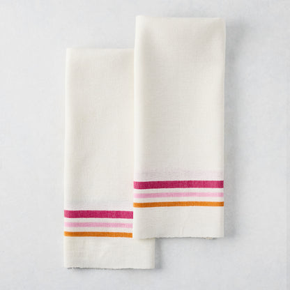Set of 2 white cotton-linen hand towels with pink and orange triple stripes.