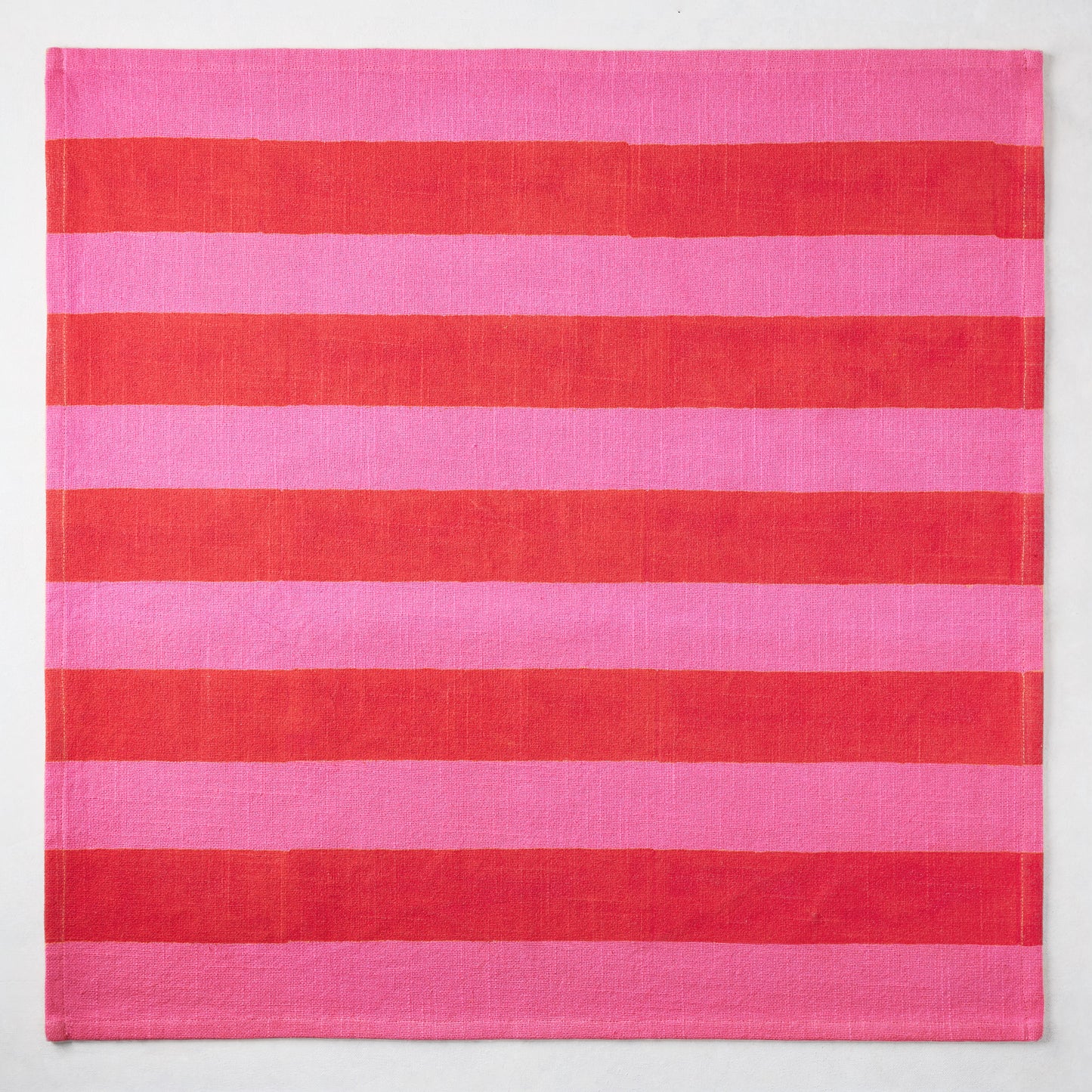 Pink and red tonal Hampton Stripe cotton napkin, 22" square.