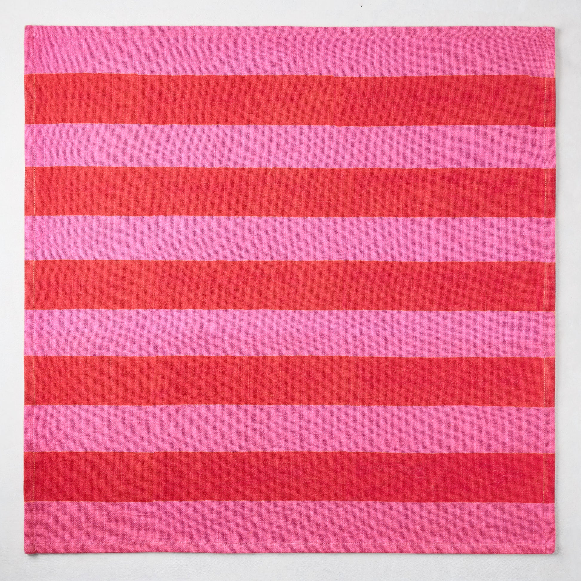 Pink and red tonal Hampton Stripe cotton napkin, 22" square.