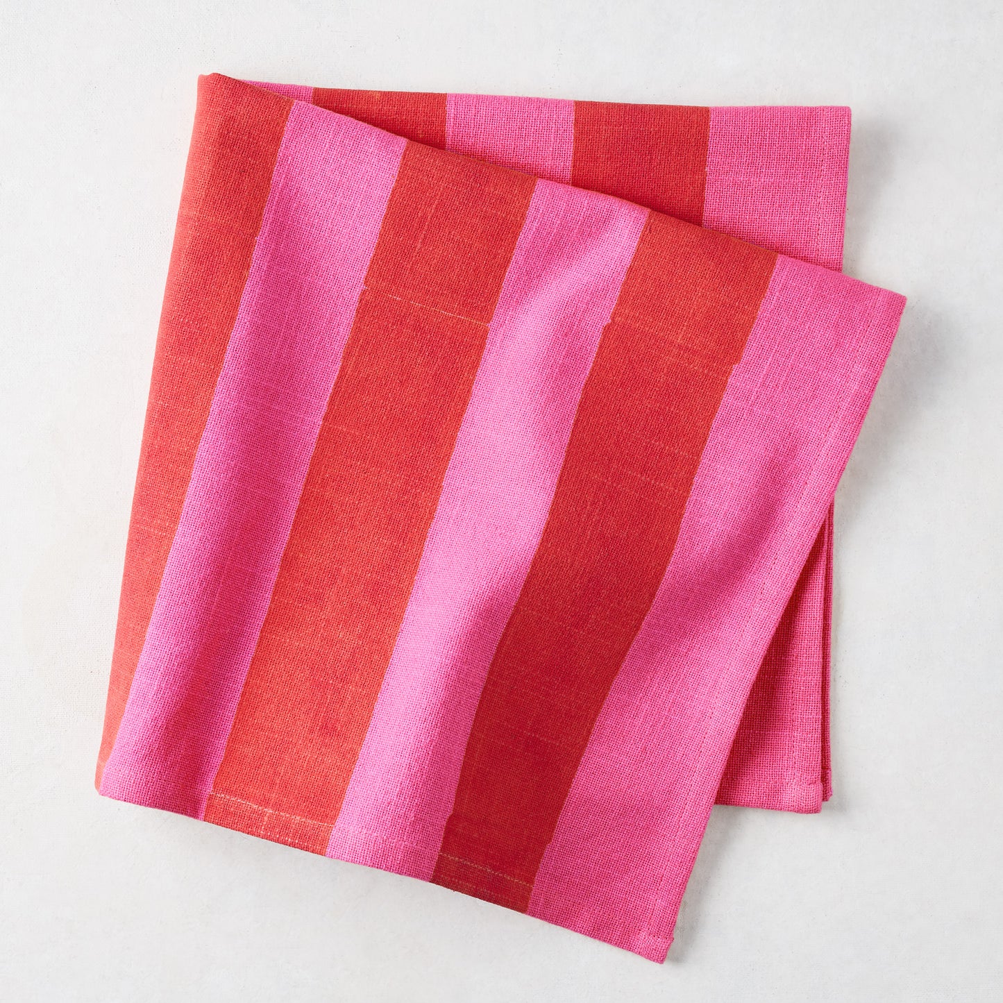 Folded Pink and Red Tonal Hampton Stripe Cotton Napkin, 22" square.