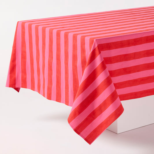 Pink and red tonal Hampton stripe cotton tablecloth, 70"W x 108"L, draped over a white surface.