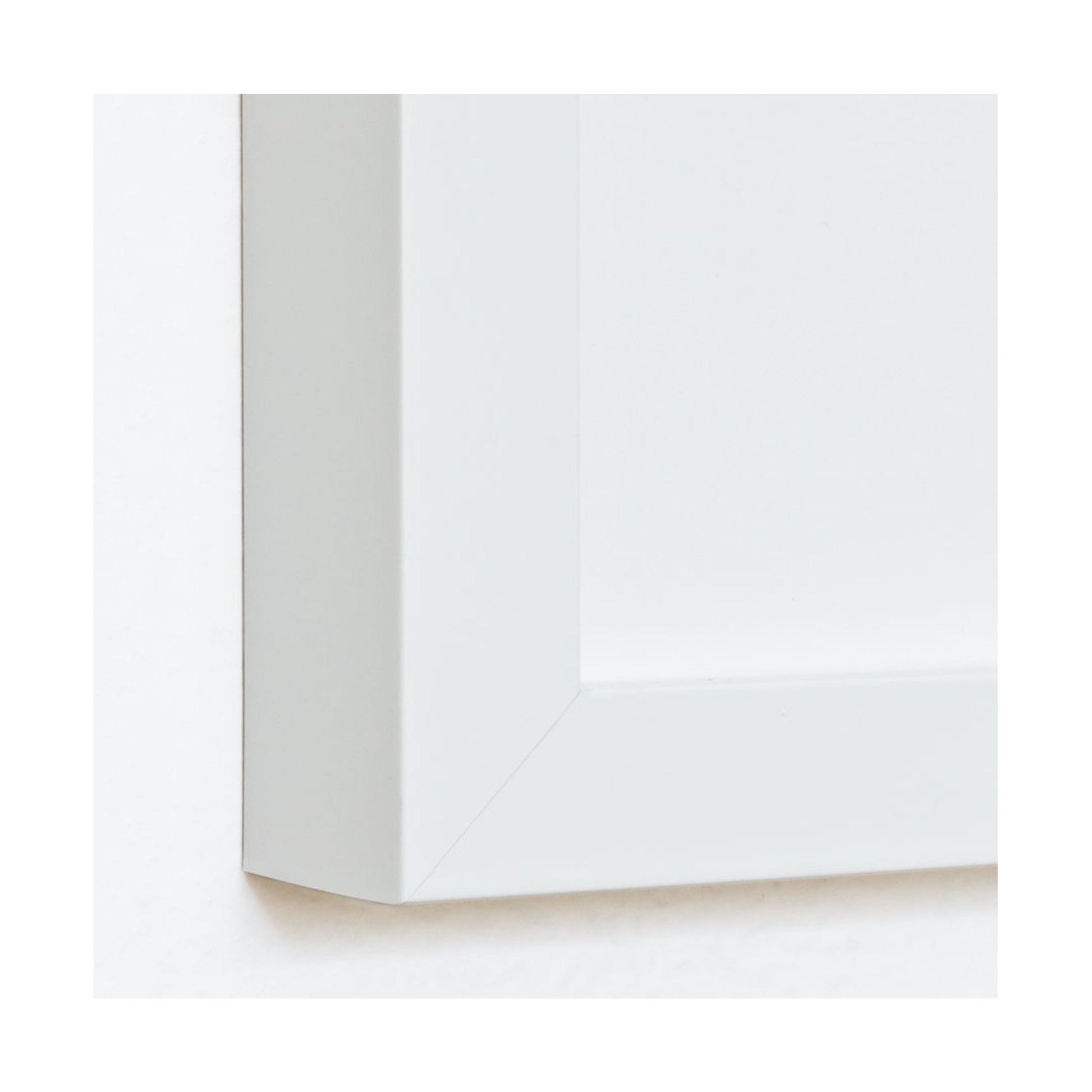 Close-up of a matte white premium wood frame molding with UV-blocking acrylic glass.