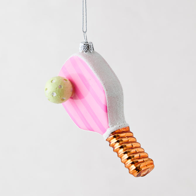 Pink and white striped pickleball paddle Christmas ornament with a lime green ball and metallic copper handle.