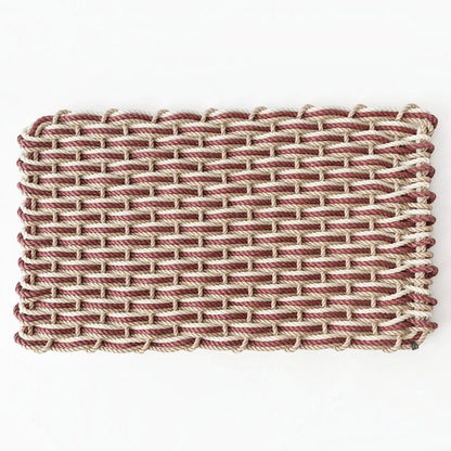 Hudson Grace handwoven rope doormat in pomegranate, sand, and oyster colors, suitable for all-weather outdoor use.