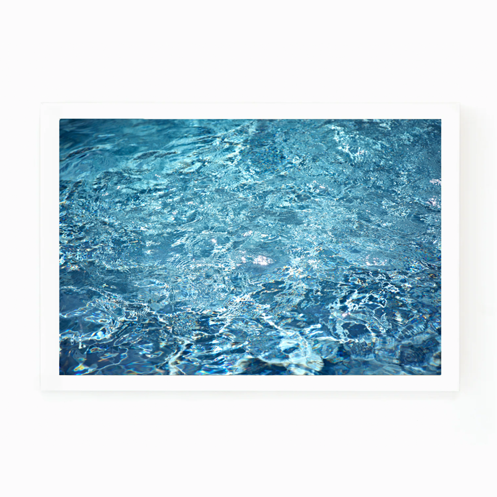 Matt Albiani's "Pool Details" photograph, framed, showing shimmering blue water with ripples and reflections.