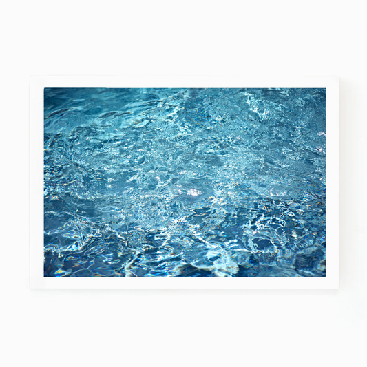 Matt Albiani's "Pool Details" photograph, framed, showing shimmering blue water with ripples and reflections.