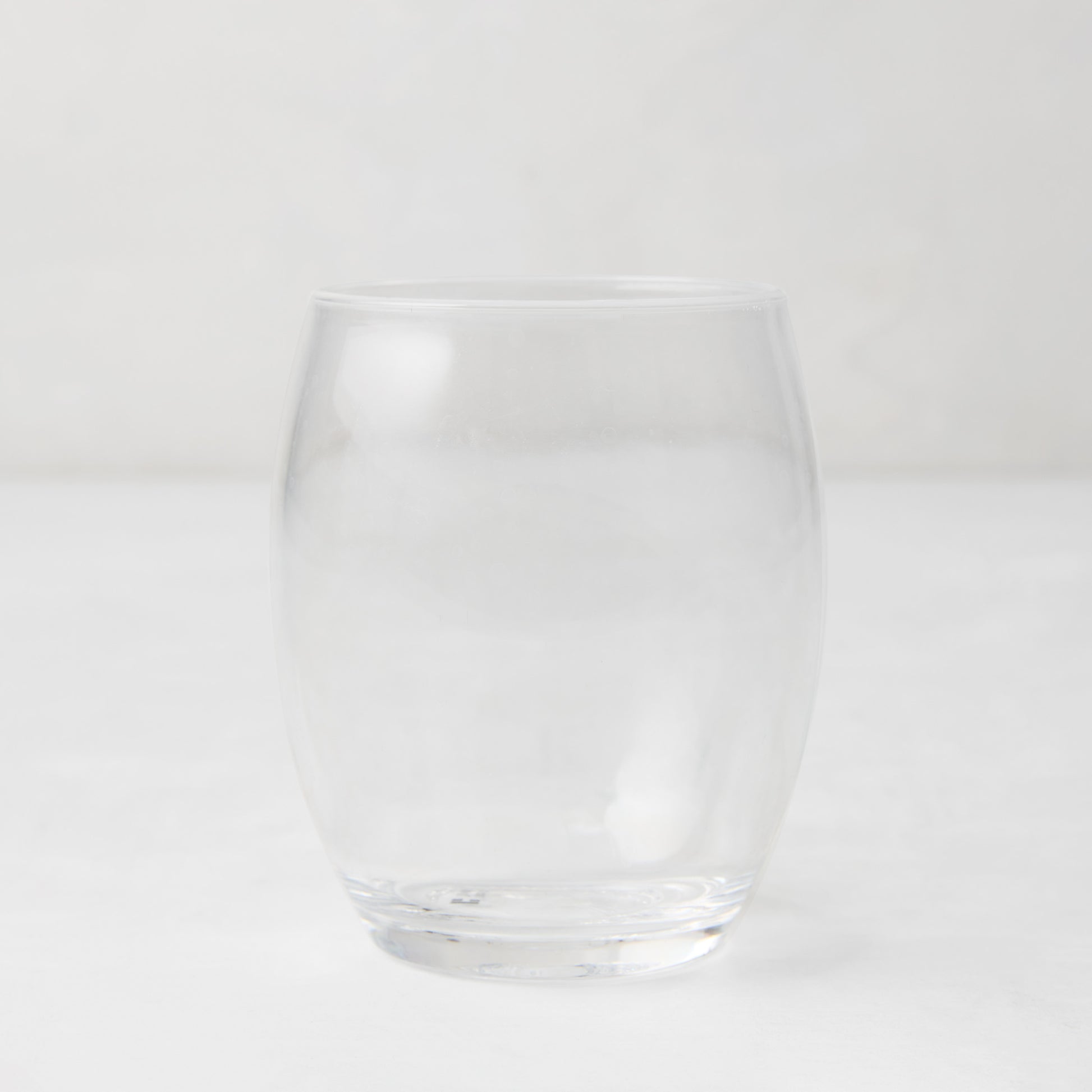 Clear 18oz Poolside Acrylic Stemless Wine Glass with a sturdy bottom and smooth lip.