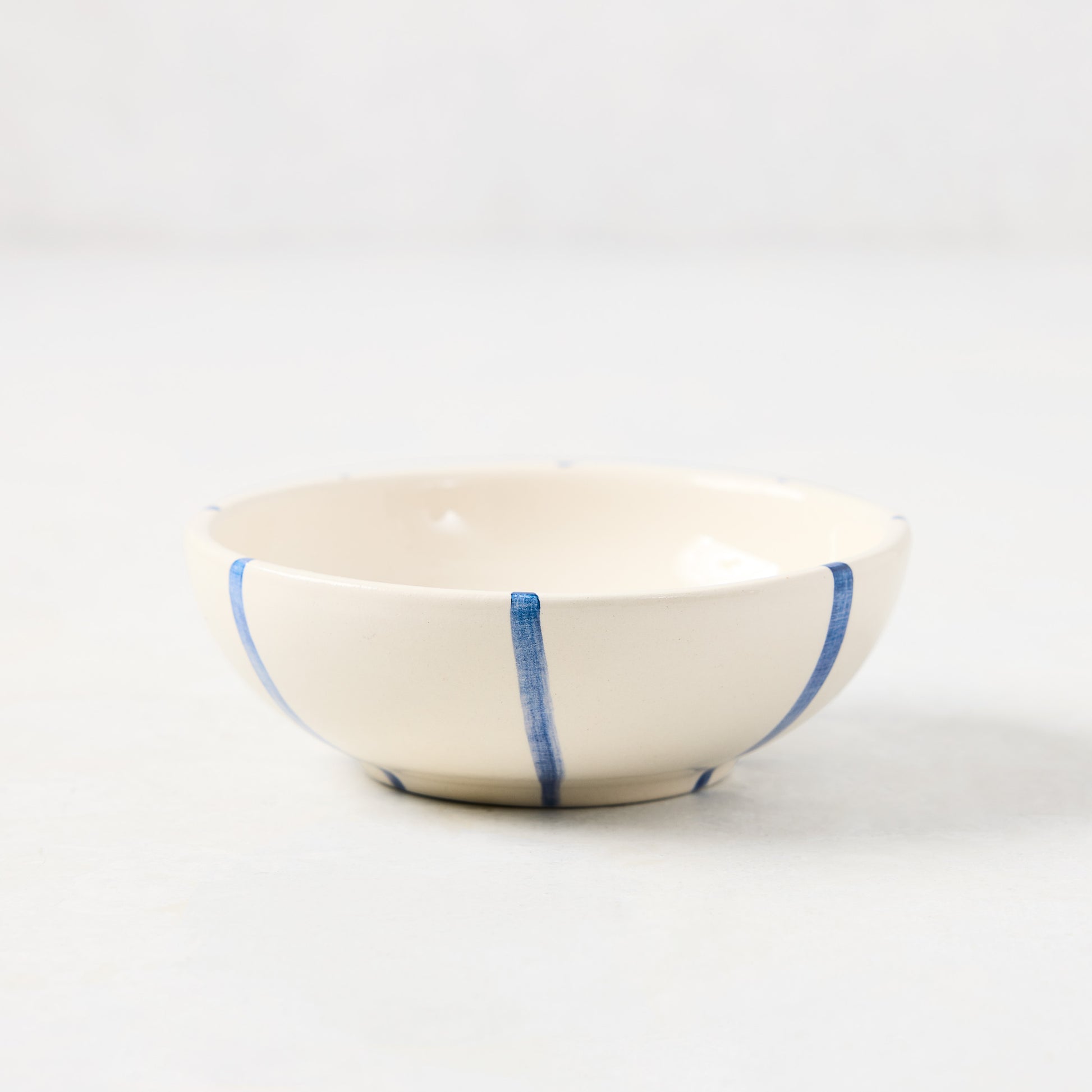 Portofino Blue Stripe Ceramic Dipping Bowl, 3.54"Dia, with hand-painted blue vertical stripes.