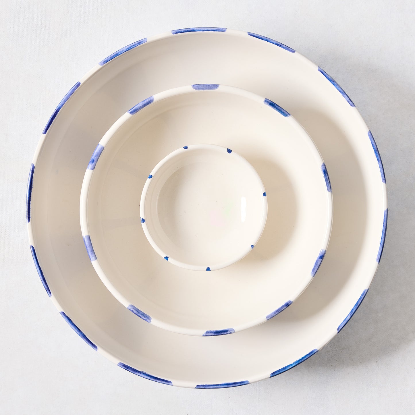 Portofino Blue Stripe ceramic stoneware bowls, nested, with hand-painted blue stripes.