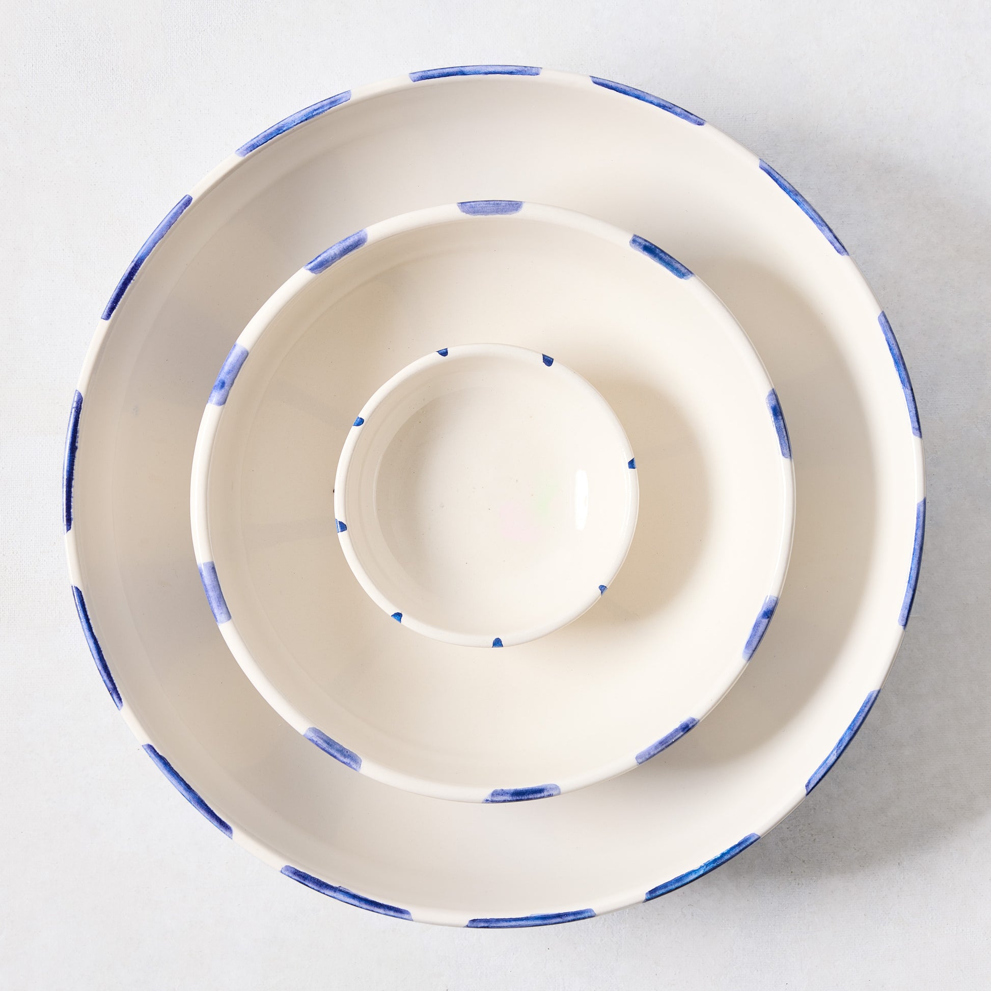 Portofino Blue Stripe ceramic stoneware bowls, nested, with hand-painted blue stripes.