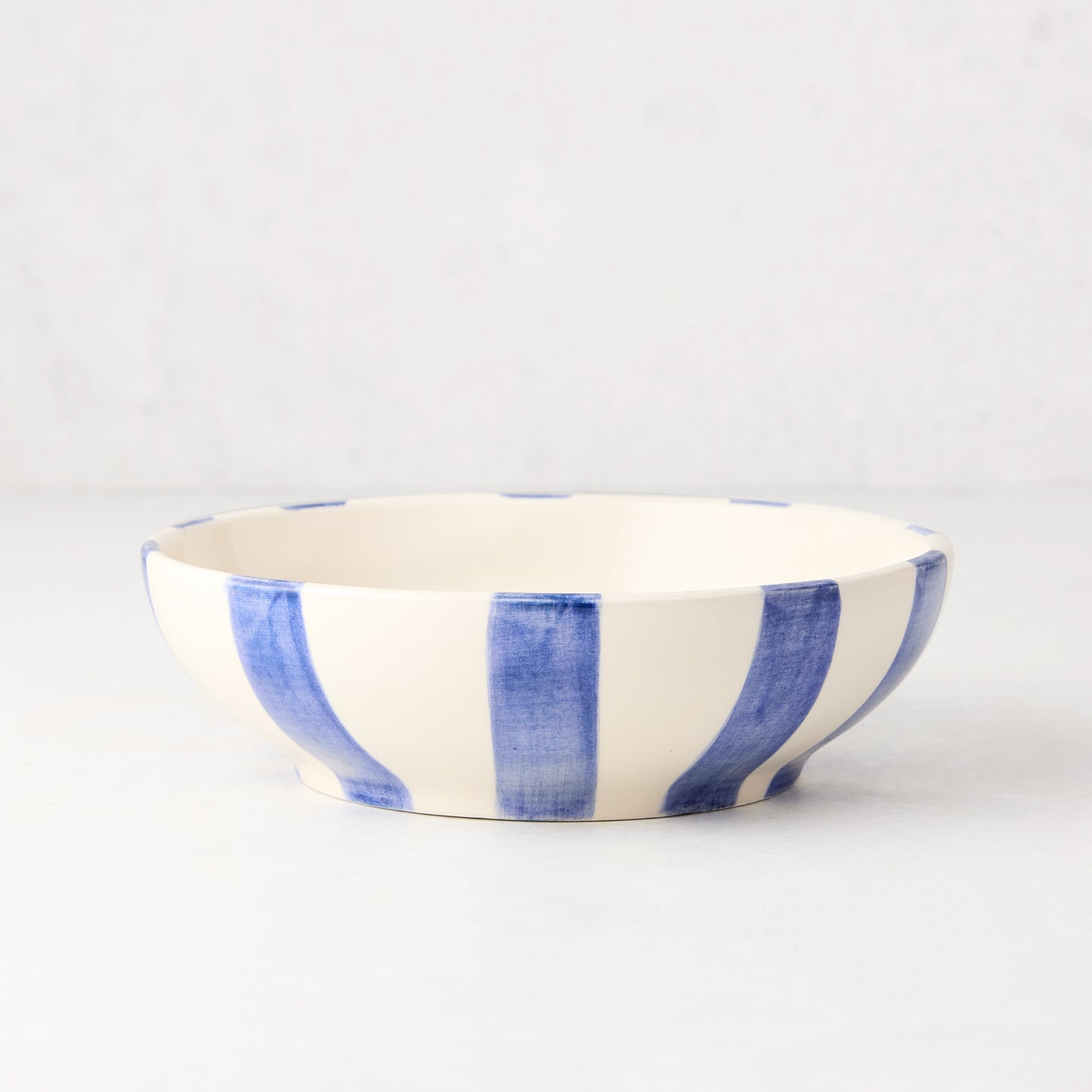 Portofino Blue Stripe Ceramic Stoneware Bowl, medium, with hand-painted blue vertical stripes on cream.