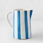 Portofino Blue Stripe Medium Ceramic Pitcher, white with hand-painted blue vertical stripes, curved handle and spout.