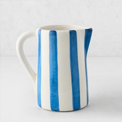Portofino Blue Stripe Medium Ceramic Pitcher, white with hand-painted blue vertical stripes, curved handle and spout.