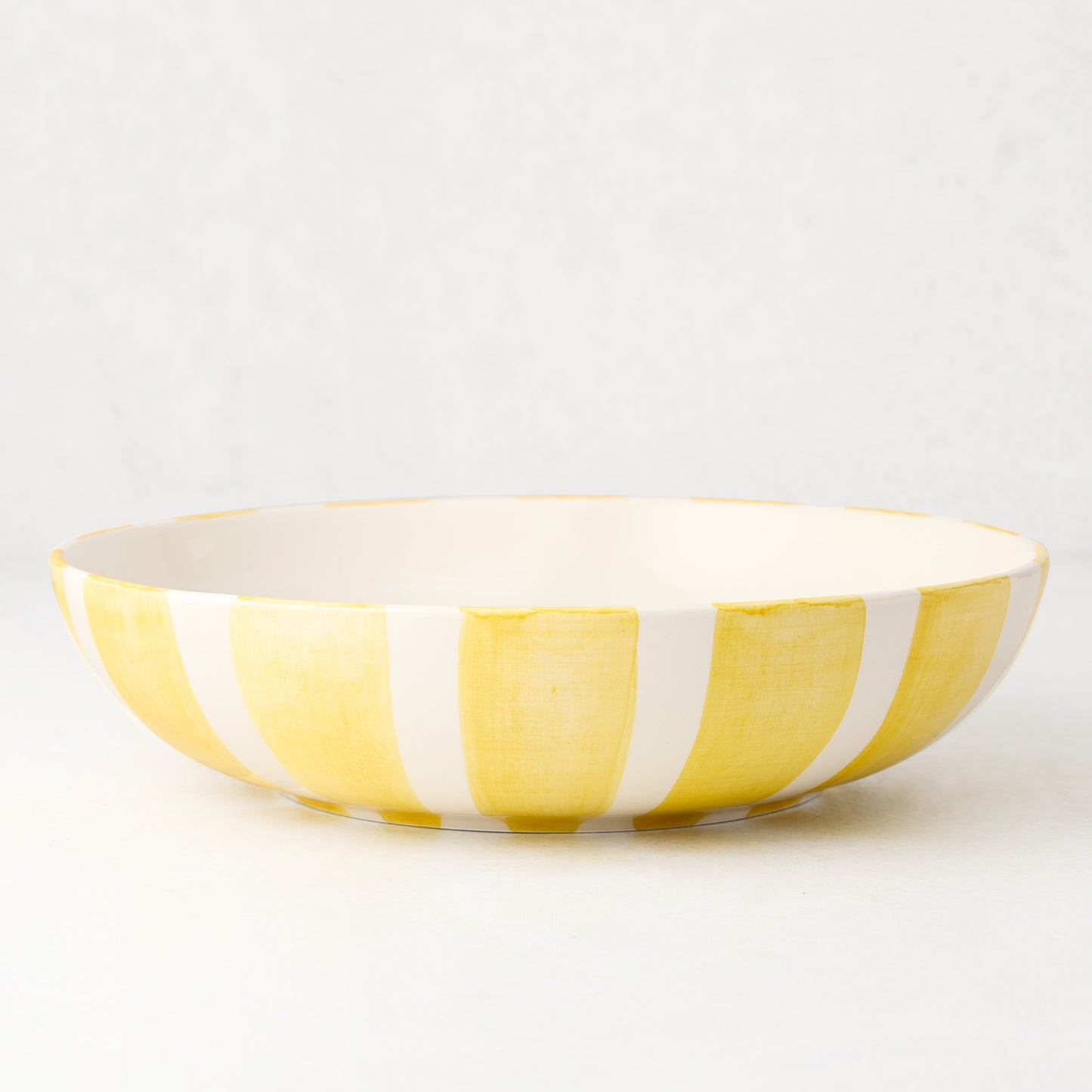 Portofino Yellow Stripe Large Ceramic Serve Bowl, hand-painted yellow and white vertical stripes.