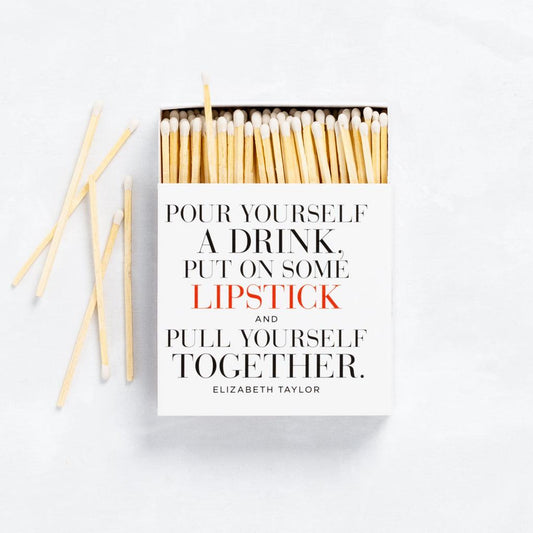 White boxed matches with "Pour Yourself a Drink, Put on Some Lipstick..." quote, featuring long natural wood sticks.