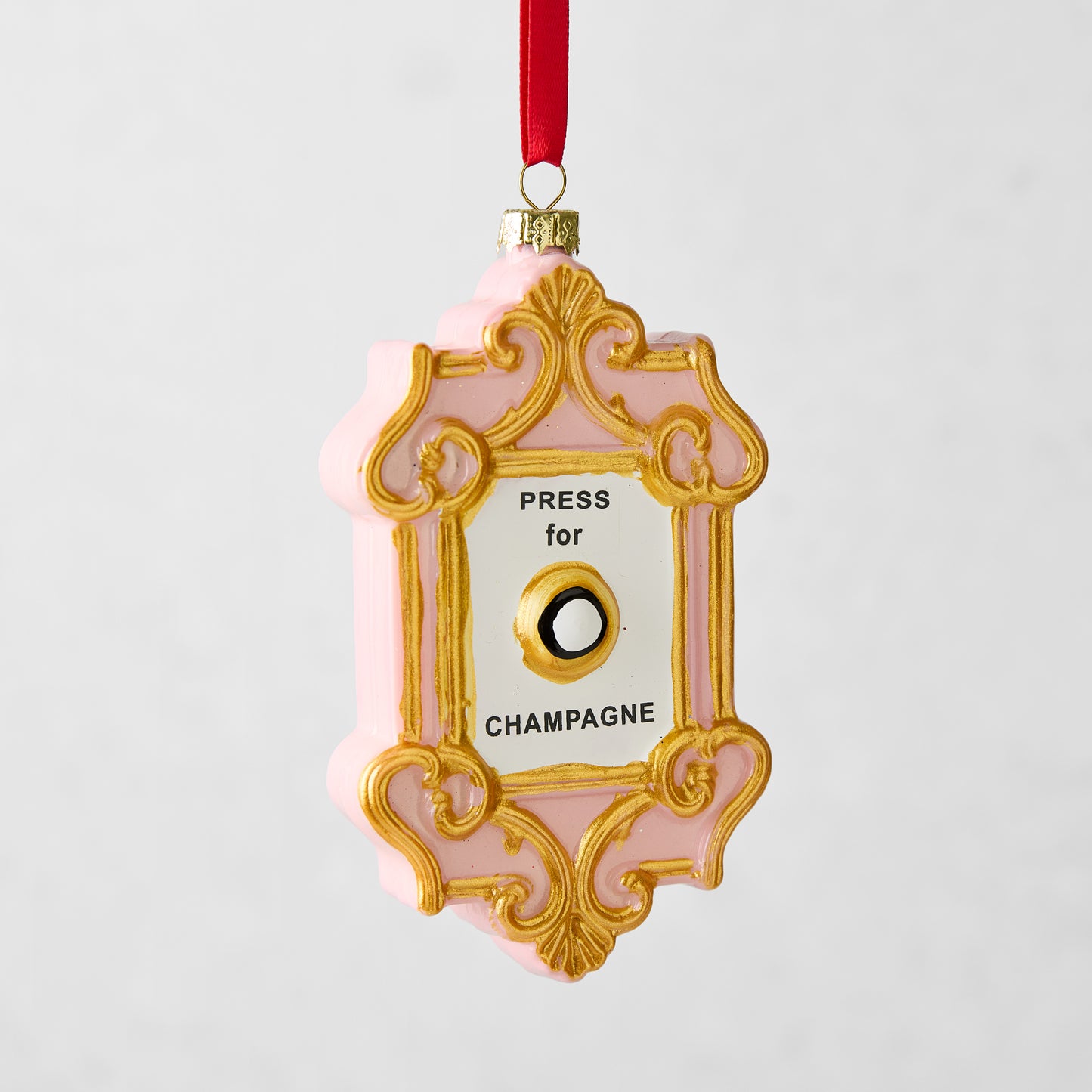 Pink and gold Press for Champagne glass Christmas ornament with a red ribbon hanger.