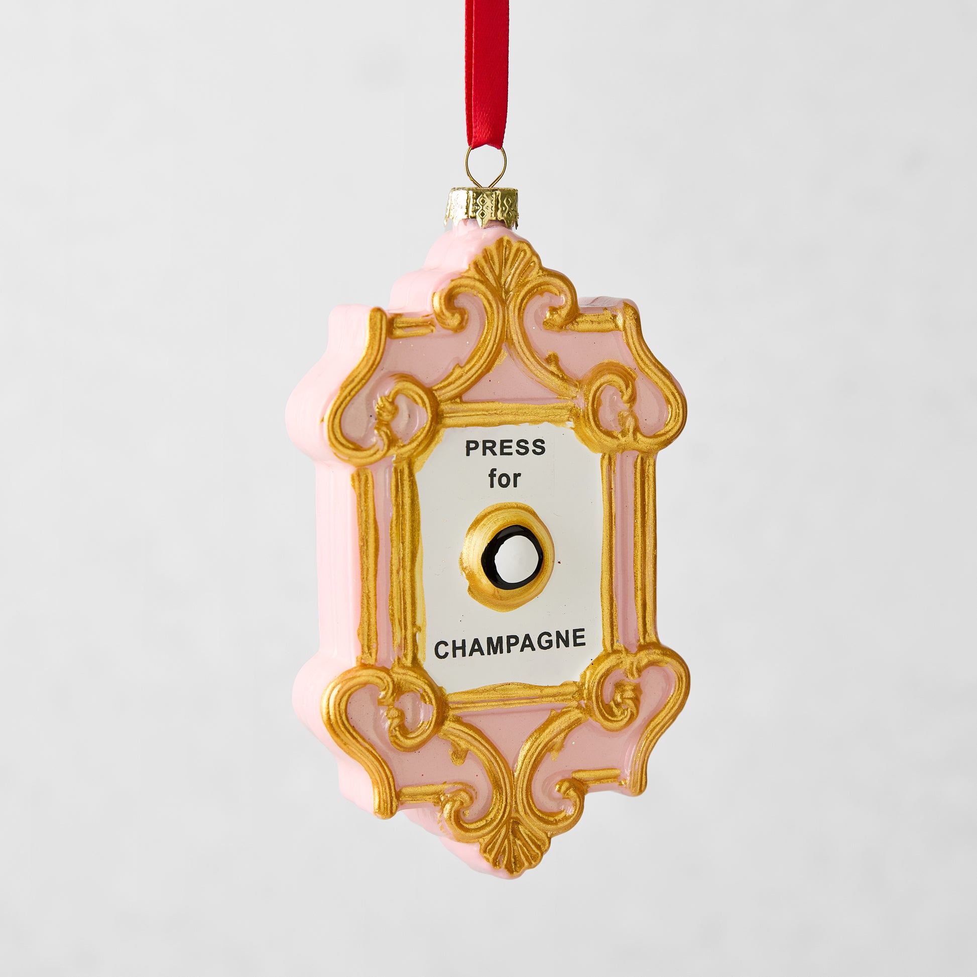 Pink and gold Press for Champagne glass Christmas ornament with a red ribbon hanger.