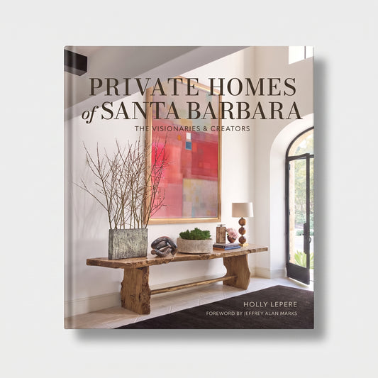 Private Homes of Santa Barbara hardcover coffee table book featuring a rustic wood console table and abstract art.