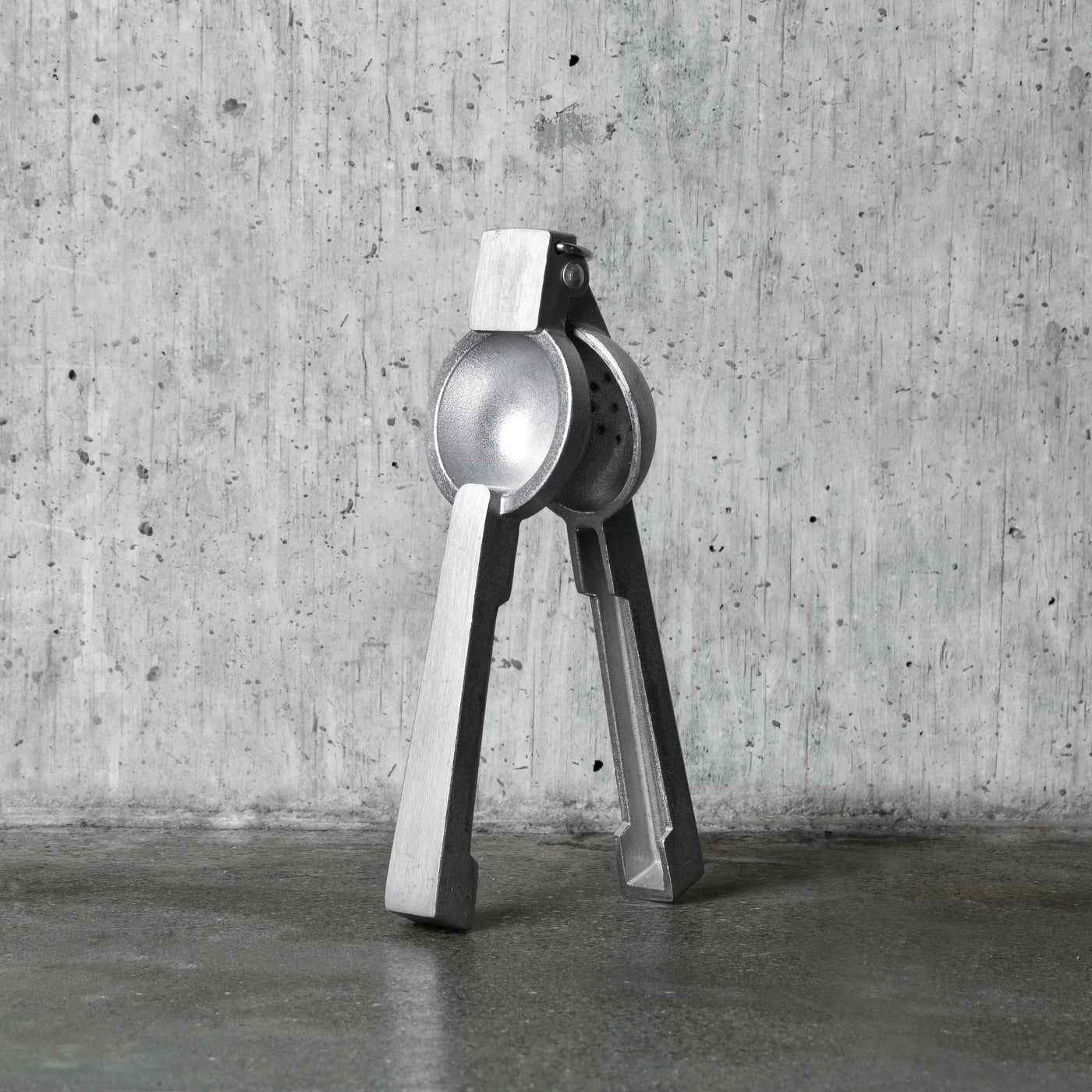 Professional silver aluminum citrus juicer, 9''H x 3''W, with polished finish.