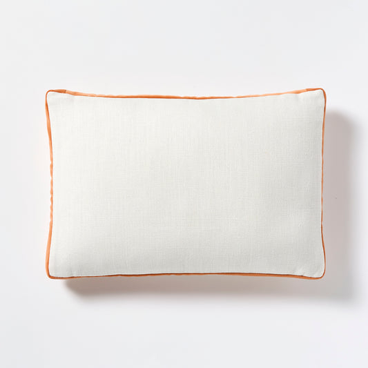 White linen lumbar pillow with pumpkin orange velvet gusset, 20x14 inches.