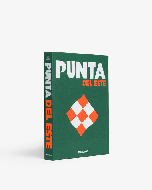 Assouline Punta Del Este hardcover book with a green fabric cover, white and orange checkered diamond, and bold typography.