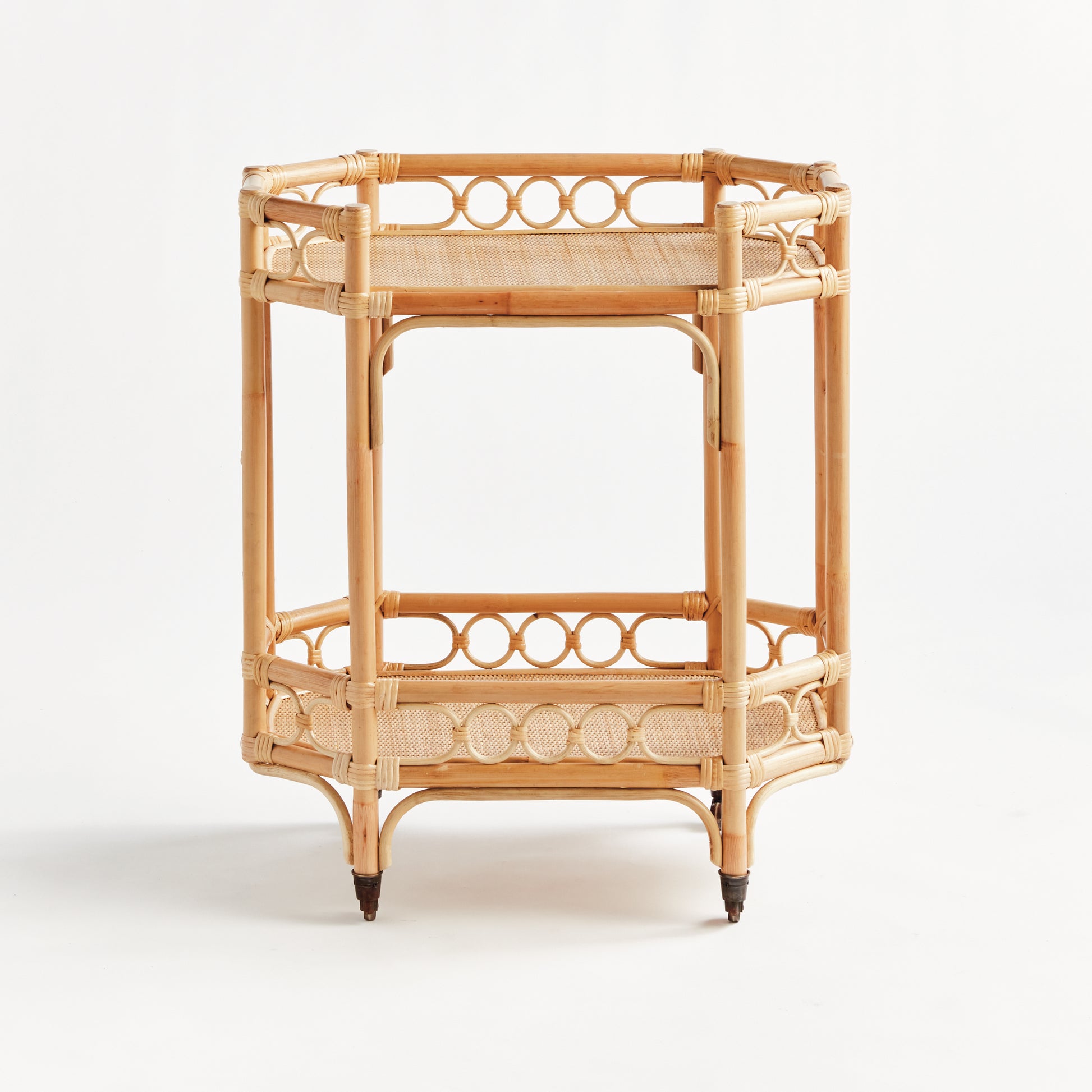 Natural Raelyn Bar Cart with handmade rattan frame, dark wood shelves, and smooth-rolling casters.