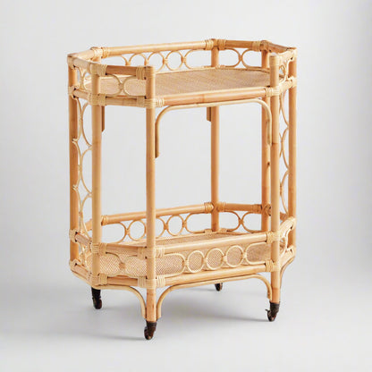 Natural Raelyn Bar Cart with two dark wood shelves, handmade rattan frame, and rolling casters.
