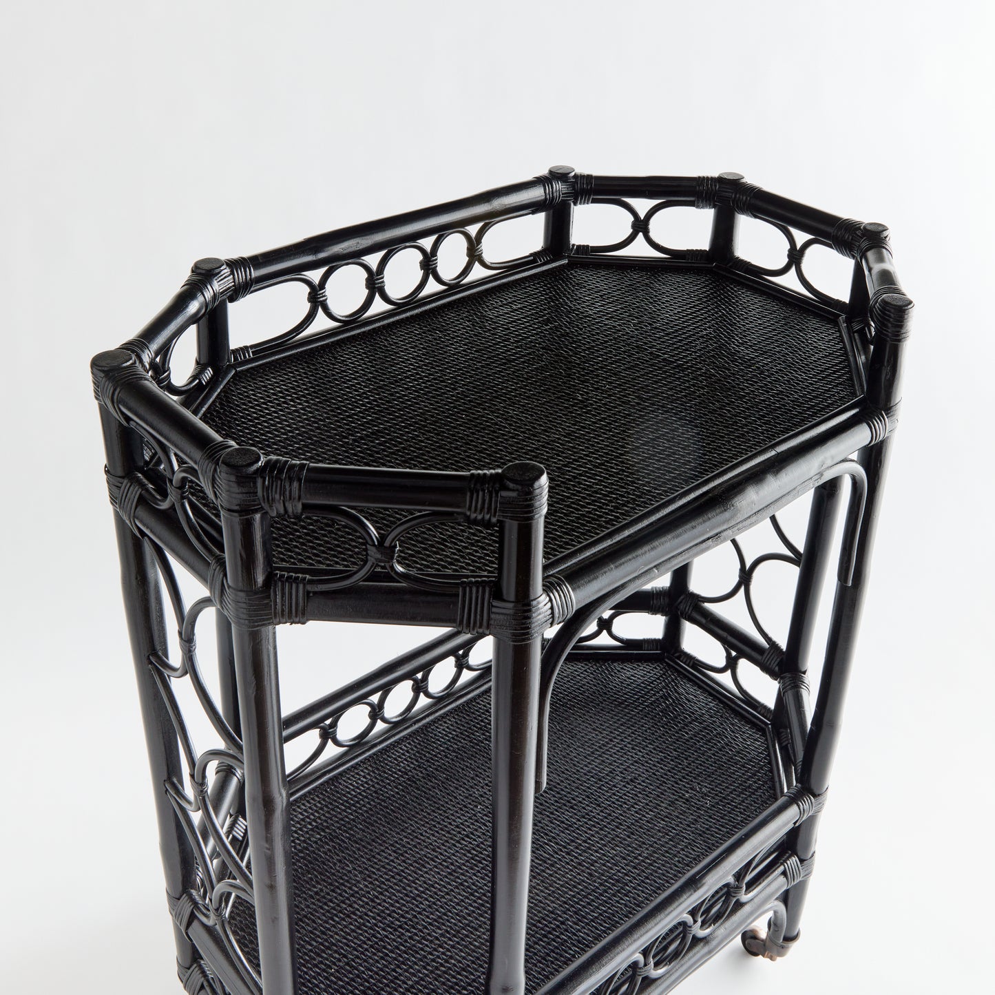 Raelyn Black Rattan Bar Cart with two dark wood shelves and smooth-rolling casters.