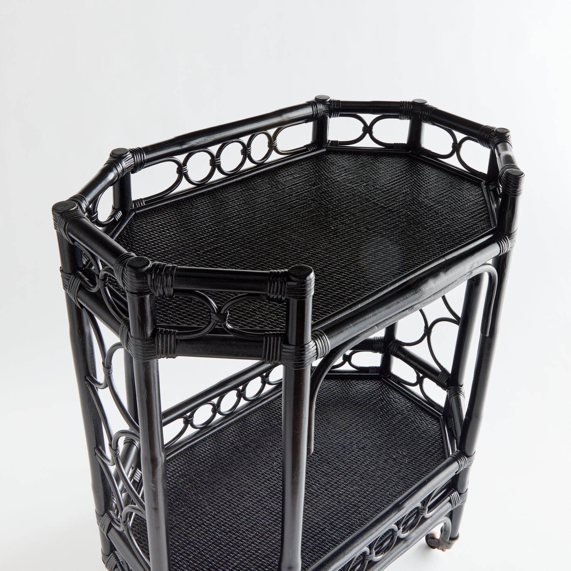 Raelyn Black Rattan Bar Cart with two dark wood shelves and smooth-rolling casters.