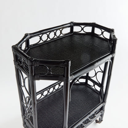 Raelyn Black Rattan Bar Cart with two dark wood shelves and smooth-rolling casters.