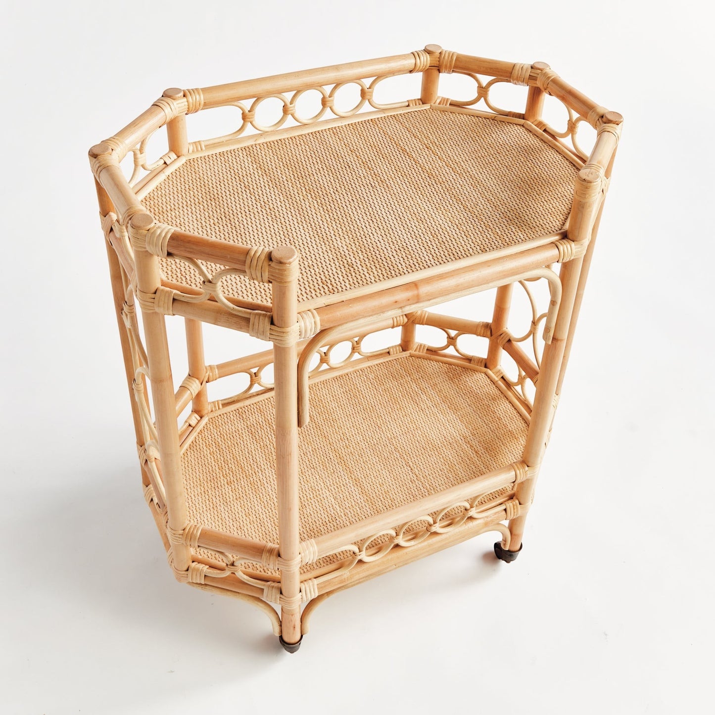 Natural Raelyn Bar Cart with two woven rattan shelves, dark wood accents, and casters.