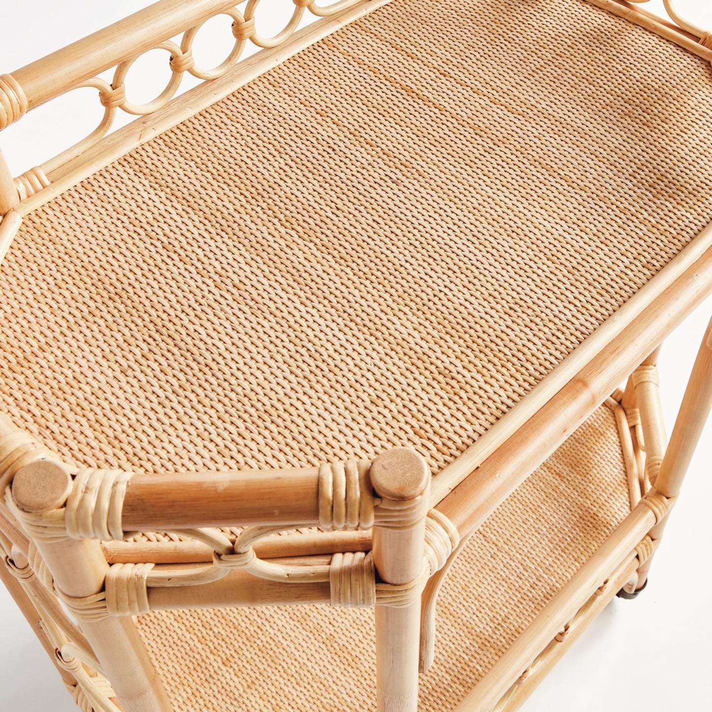 Natural rattan Raelyn Bar Cart with woven shelves and dark wood accents.