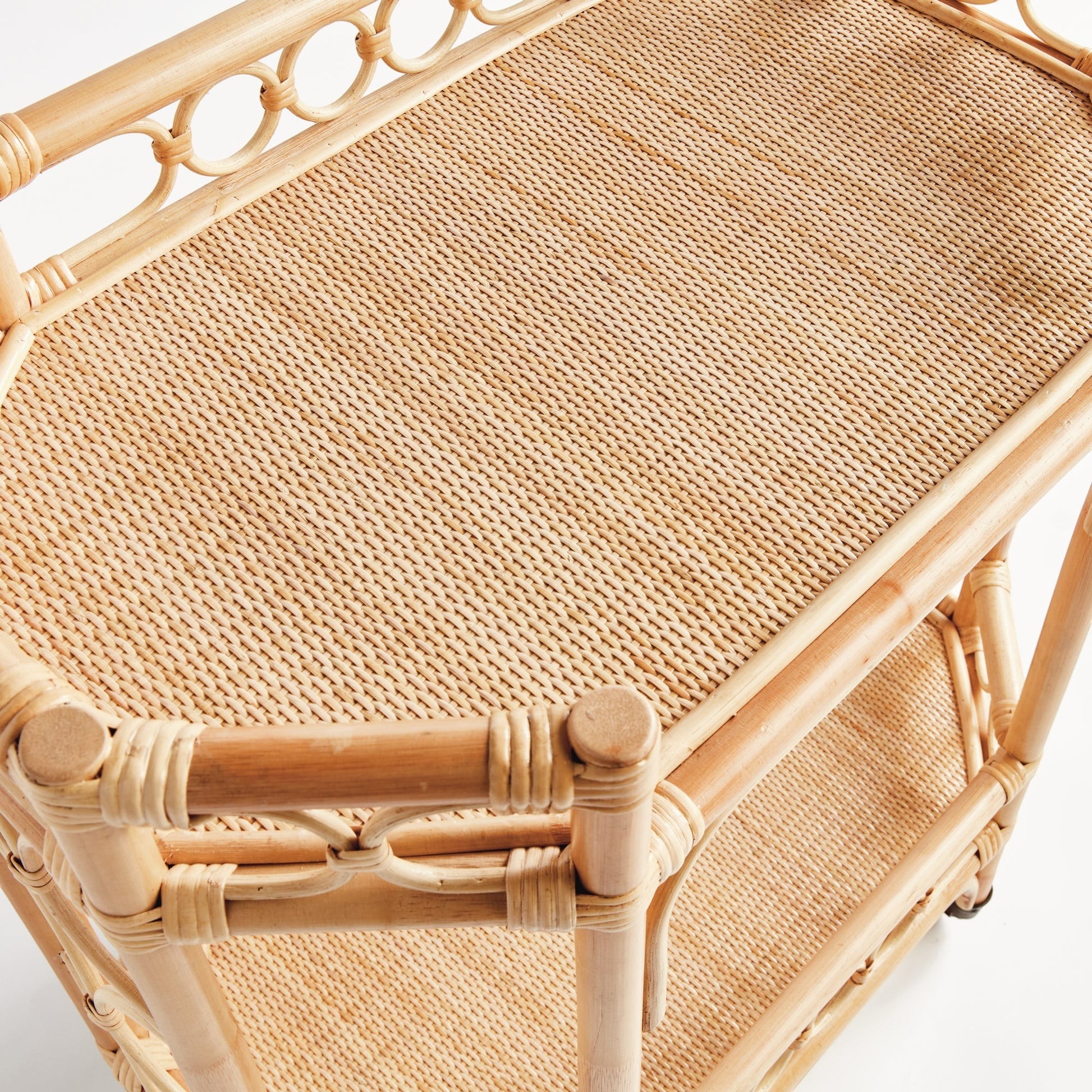 Natural rattan Raelyn Bar Cart with woven shelves and dark wood accents.