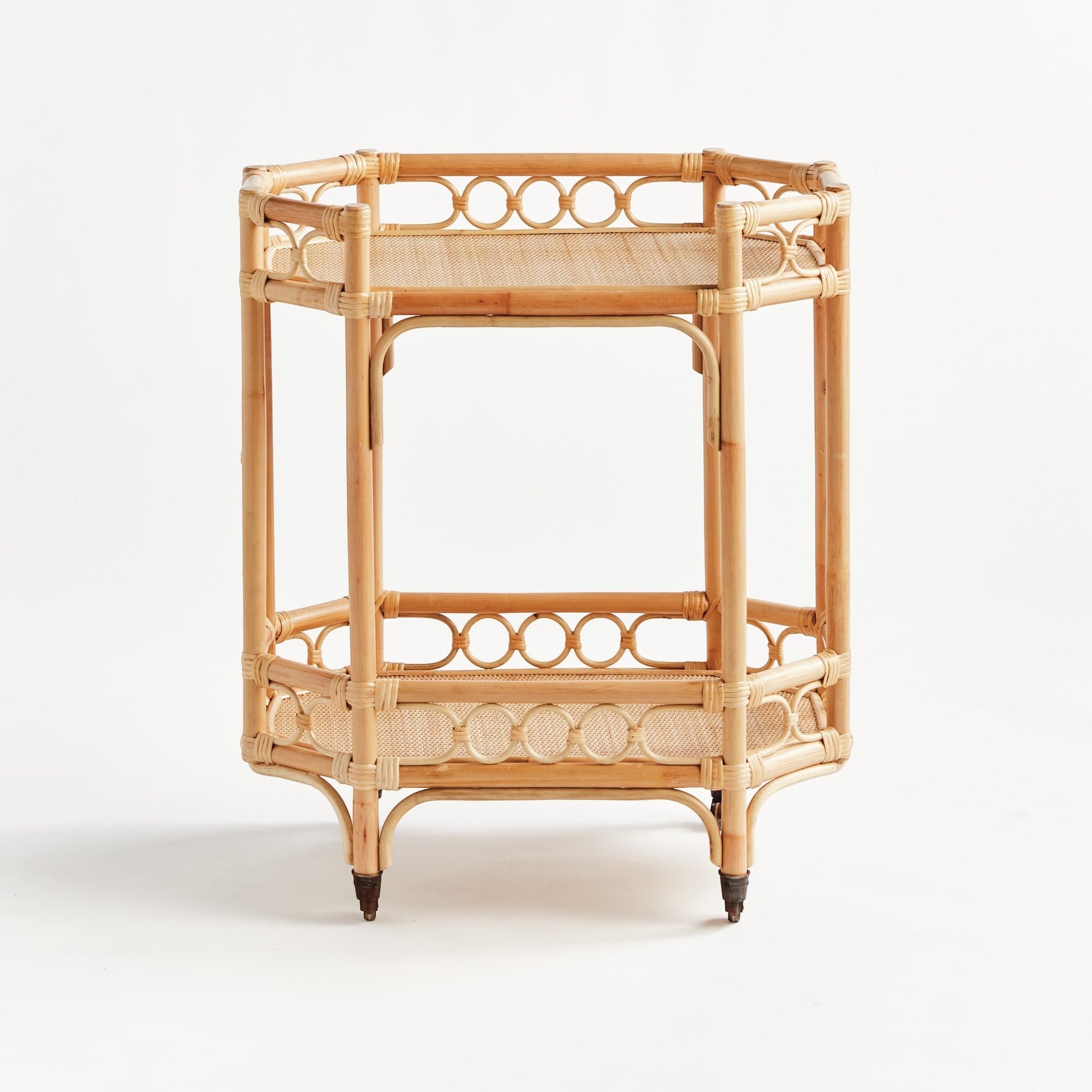 Natural Raelyn Bar Cart with handmade rattan frame, dark wood shelves, and smooth-rolling casters.