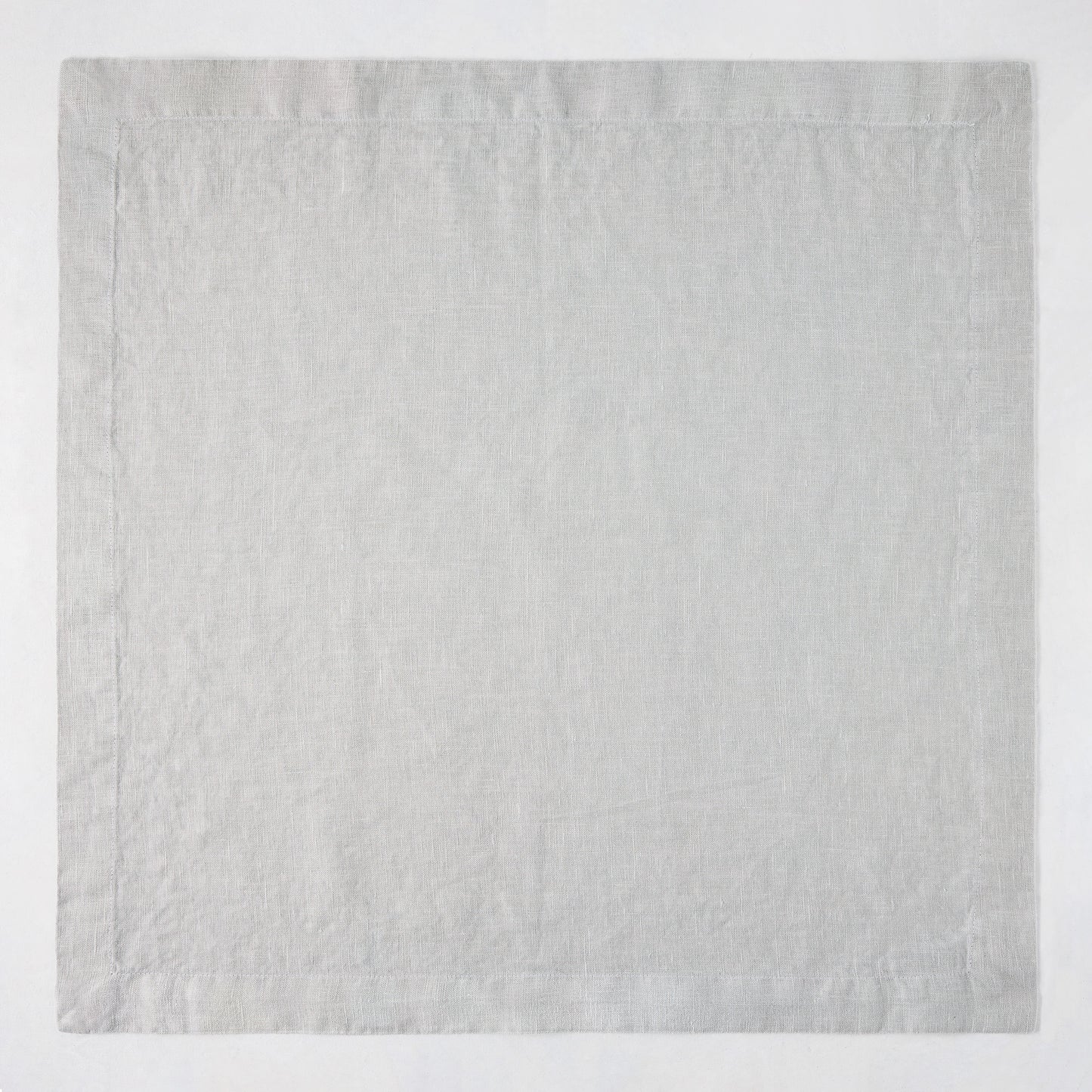 Rain HG Signature hand-dyed light grey linen napkin, 22-inch square with mitered corners.