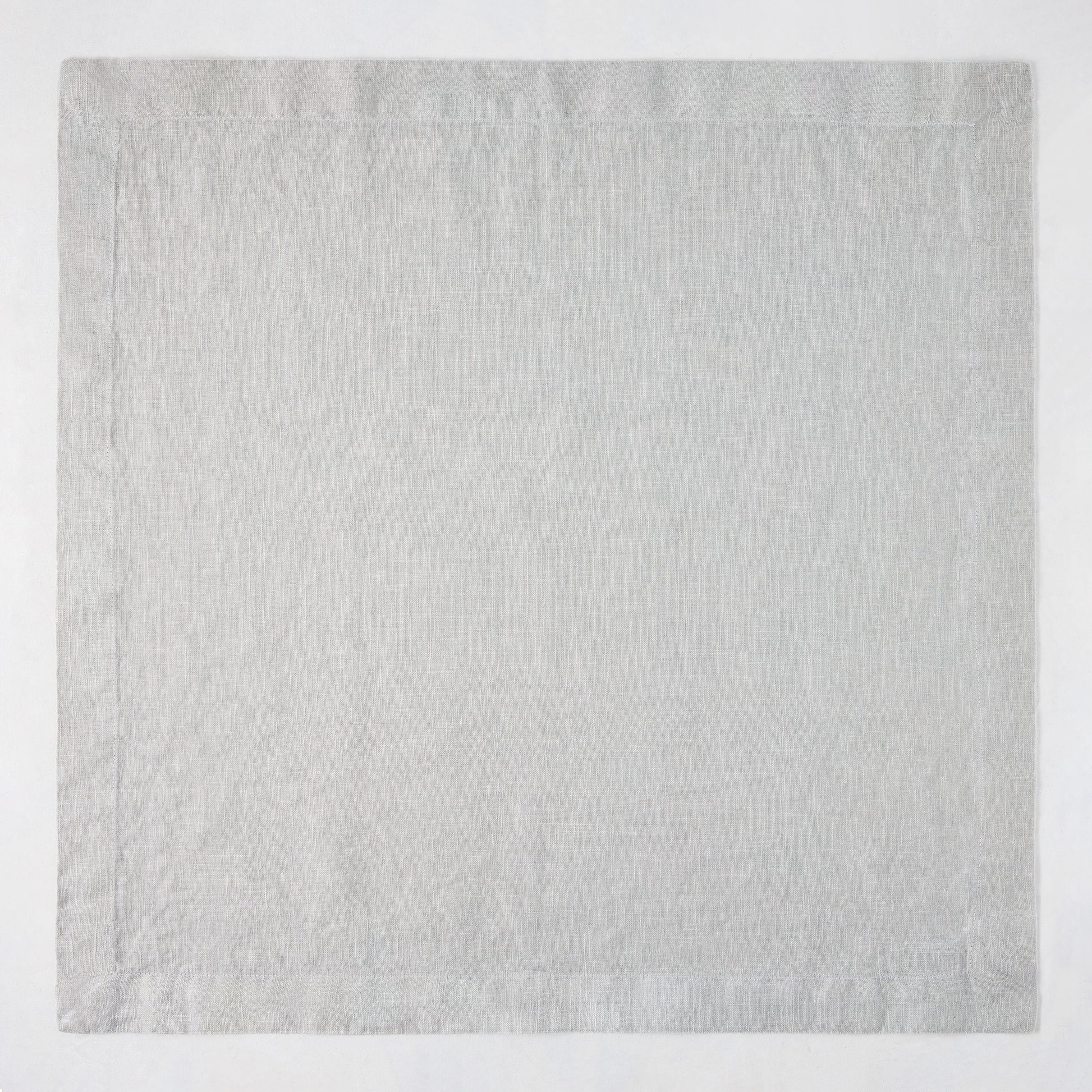 Rain HG Signature hand-dyed light grey linen napkin, 22-inch square with mitered corners.