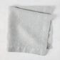 Rain HG Signature hand-dyed light grey linen napkin, 22-inch square, folded.