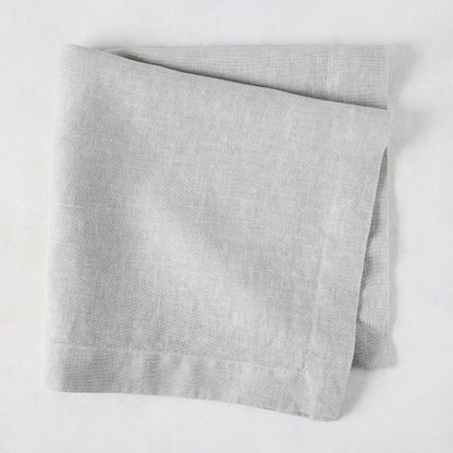 Rain HG Signature hand-dyed light grey linen napkin, 22-inch square, folded.