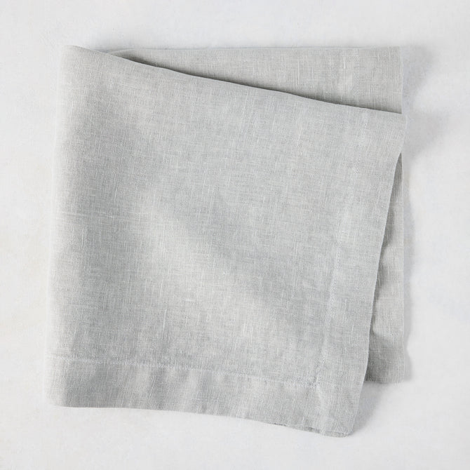Rain HG Signature hand-dyed light grey linen napkin, 22-inch square, folded.
