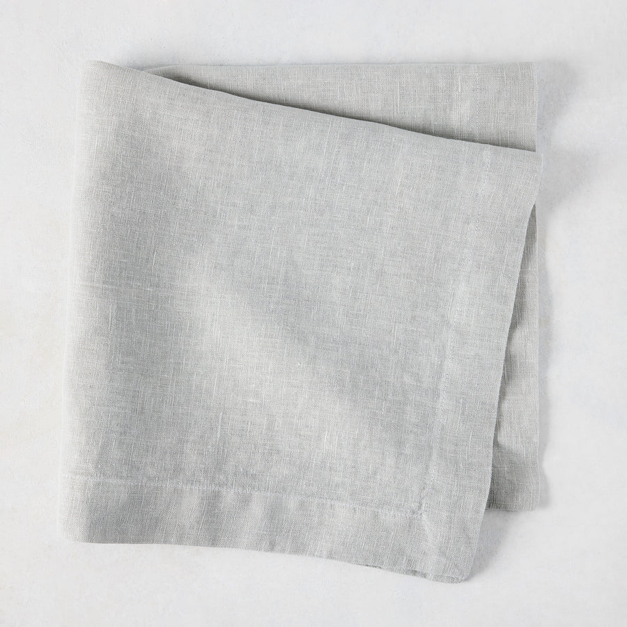 Rain HG Signature hand-dyed light grey linen napkin, 22-inch square, folded.