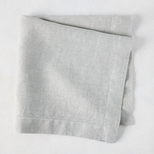 Rain HG Signature hand-dyed light grey linen napkin, 22-inch square, folded.