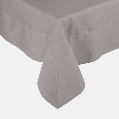 Rain HG Signature hand-dyed linen tablecloth in a soft grey, featuring a generous border and mitered corner.
