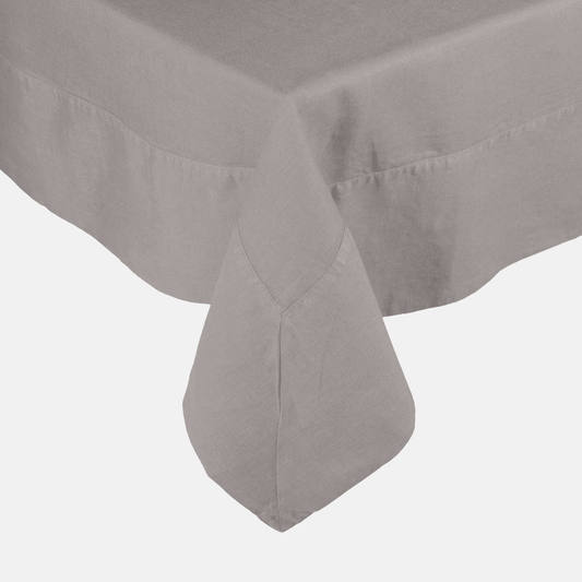 Rain HG Signature hand-dyed linen tablecloth in a soft grey, featuring a generous border and mitered corner.