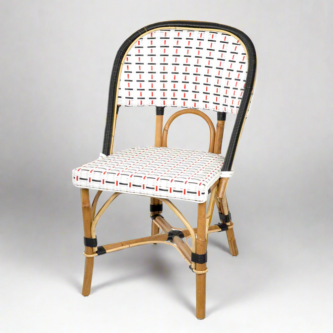 Rattan bistro chair with black frame, white, black, and red woven back and seat.
