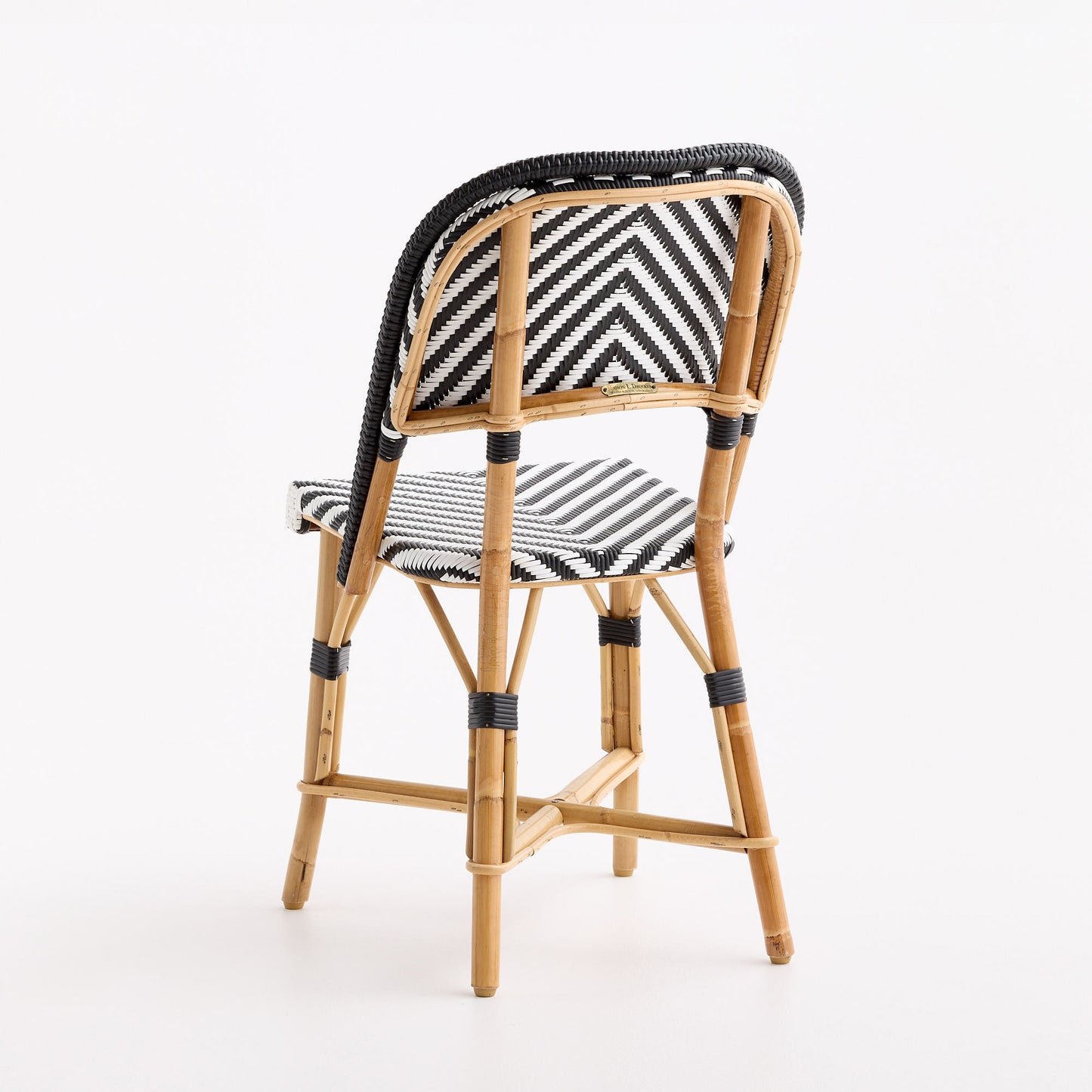 Black and white chevron woven rattan bistro chair with a natural wooden frame and black accents.