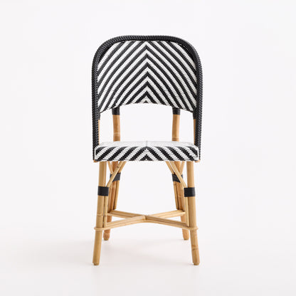 Black and white chevron woven rattan bistro chair with a natural wood frame on a white background.