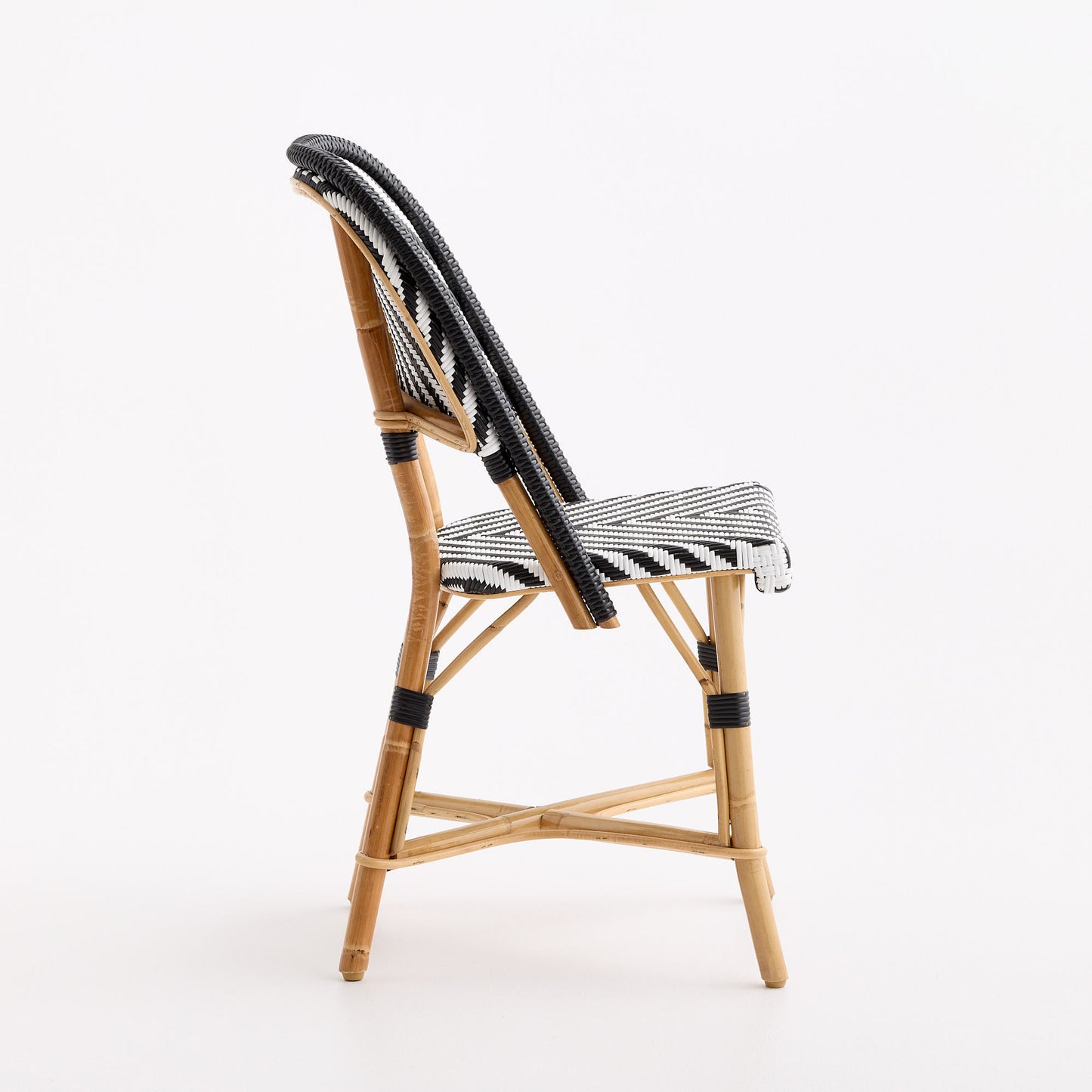 French bistro chair with natural rattan frame and black and white chevron woven seat and backrest.