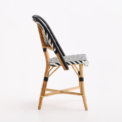 French bistro chair with natural rattan frame and black and white chevron woven seat and backrest.
