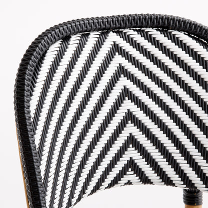 Black and white woven rattan bistro chair back with a chevron pattern and solid black border.